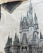 Woven Orlando castle throw blanket draped across bed.